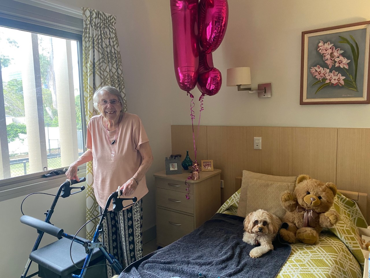 aged care resident joan celebrating her 97th birthday with balloons in her room