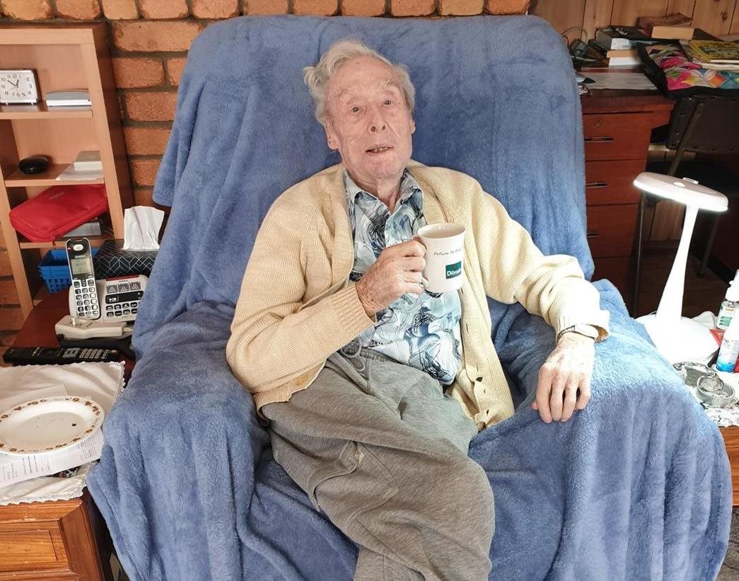 cathy's dad jack sitting at home in the lounge with a cup of tea