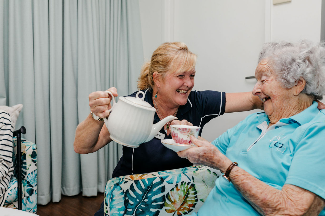 aged care worker pouring tea for a resident