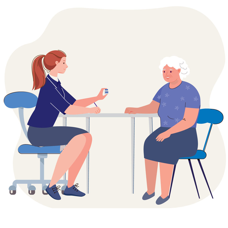 an nurse chatting with an elderly person at a table